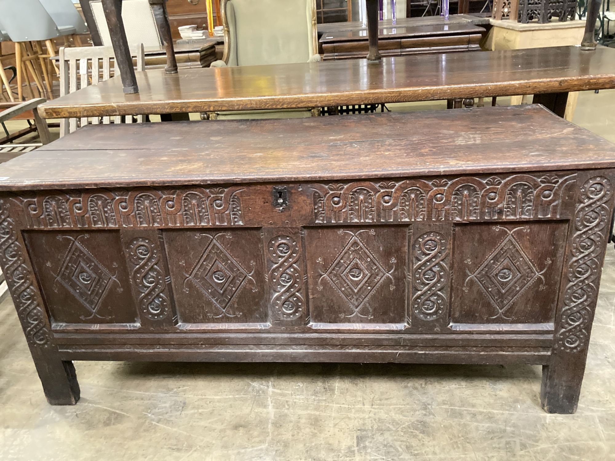 An 18th century carved panelled oak coffer, length 149cm, depth 62cm, height 67cm